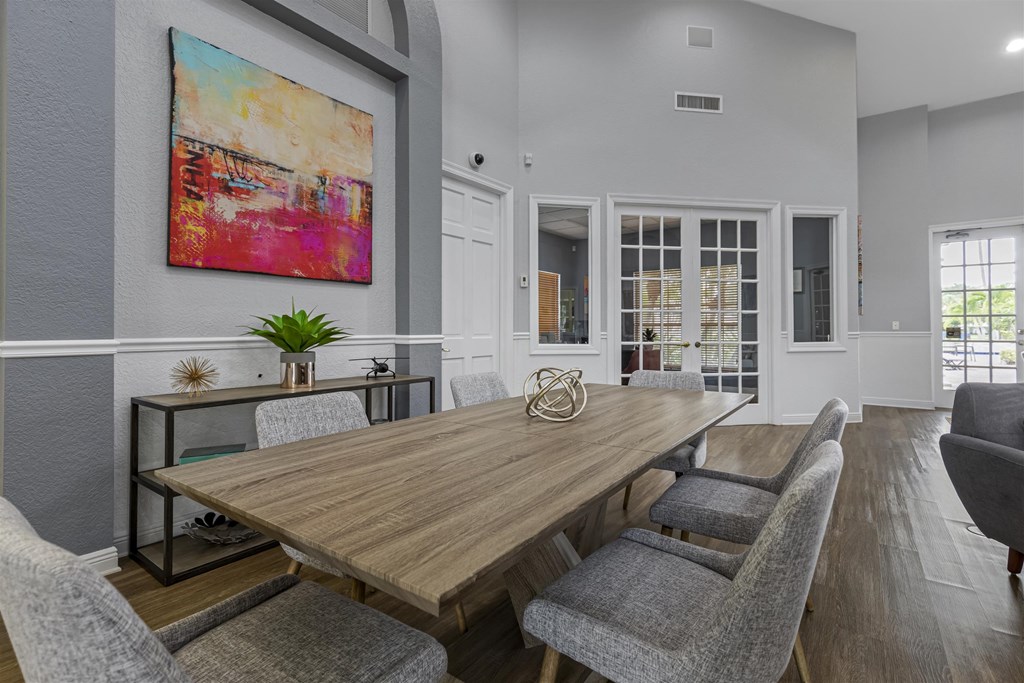 a dining room with a wooden table and chairs