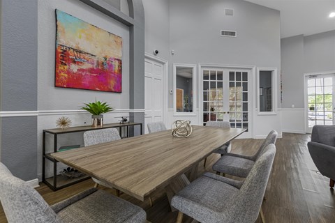 a dining room with a wooden table and chairs