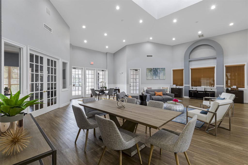 a living room with a table and chairs and a large living room