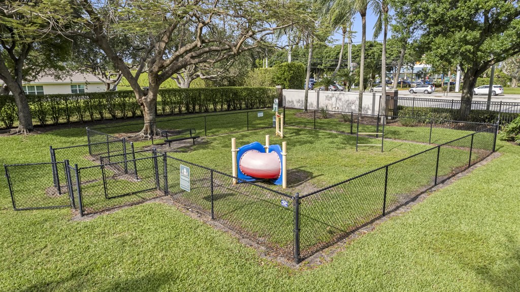 a playground with a ball in the middle of a fence