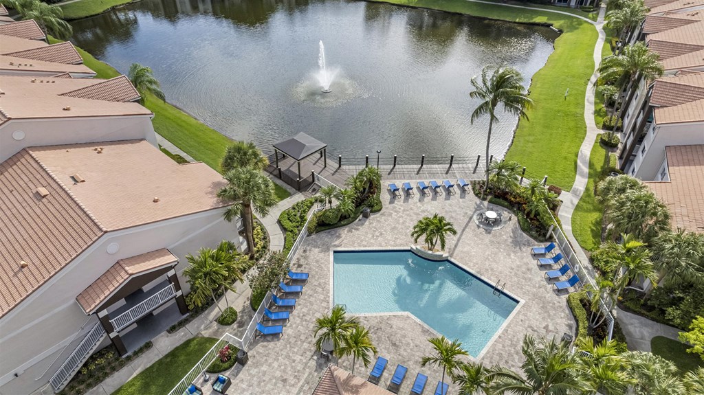 Beautiful drone shot overview of pool, clubhouse and lake area