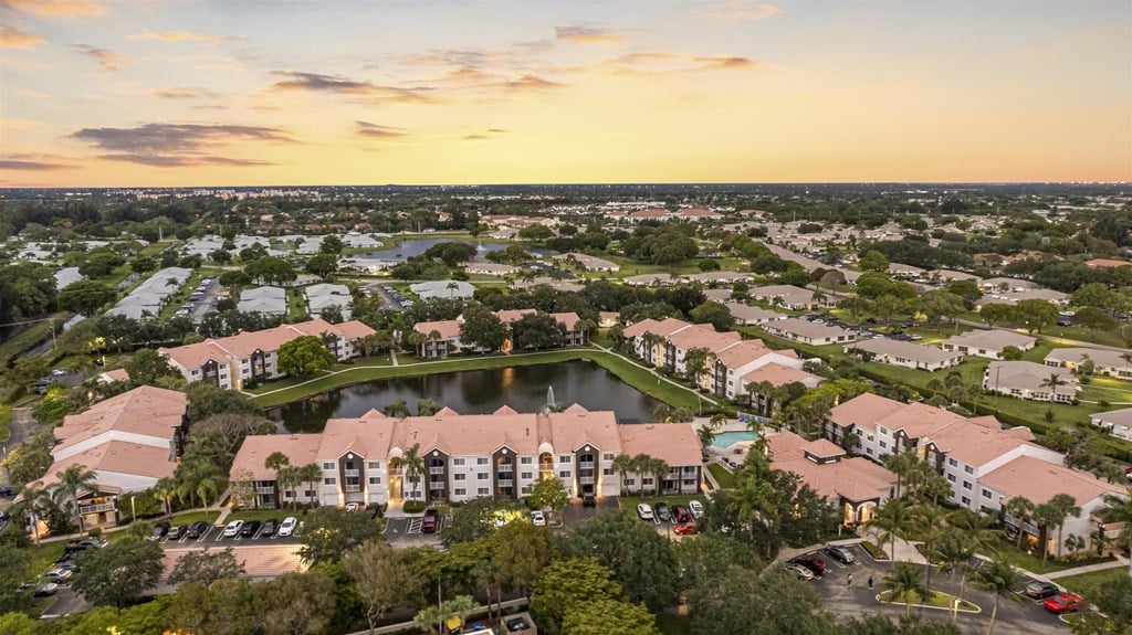 an aerial view of a community with a lake and buildings