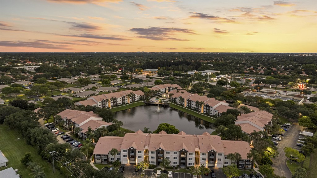 an aerial view of a community with a lake and residential buildings