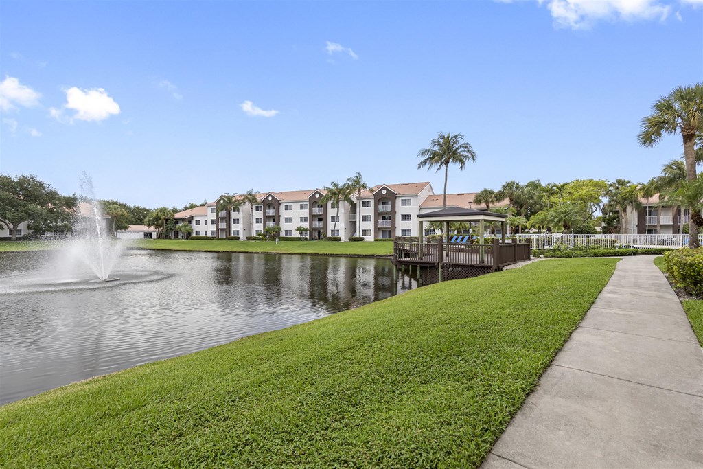the park at the waters edge of a lake with a fountain