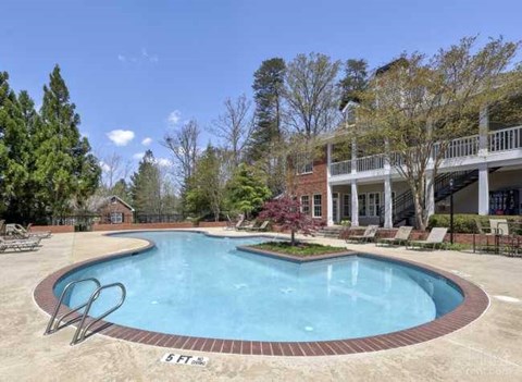 a large swimming pool in front of a house