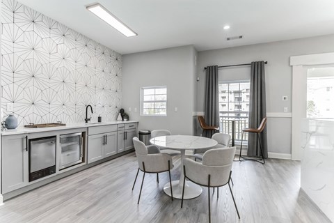 A modern kitchen with a dining table and chairs.