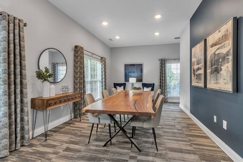 a dining room with a wooden table and chairs