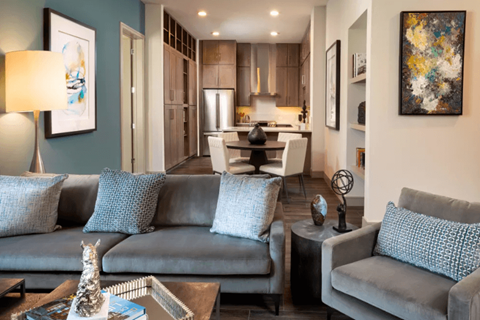 A living room with a grey couch and a coffee table.