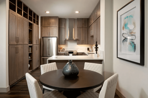 A modern kitchen with a dining table and chairs.