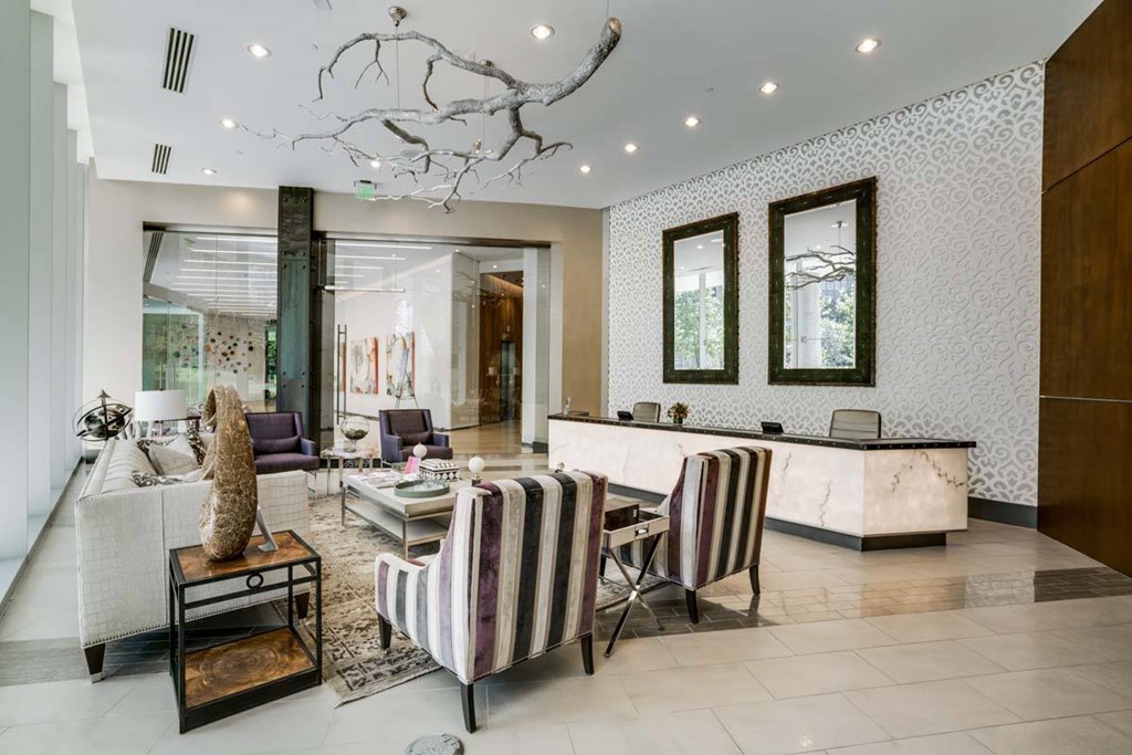 A modern living room with a striped chair and a marble counter.