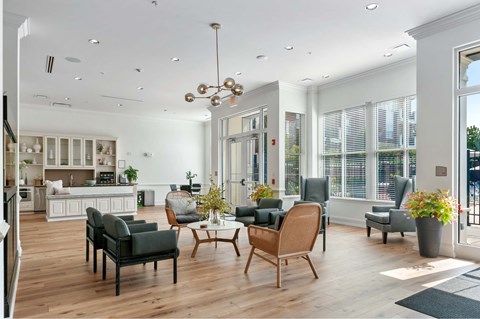 A modern living room with a kitchen in the background.