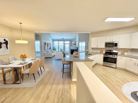 A modern kitchen with a dining table set for four.