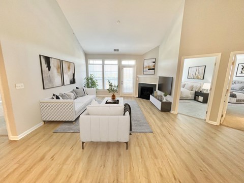 A living room with a white sofa and a grey armchair.