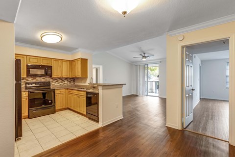 A kitchen with wooden cabinets and a white ceiling.