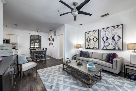 A modern living room with a grey sofa and a coffee table.