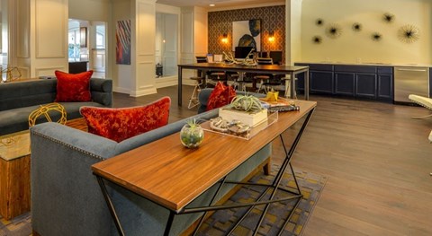 A modern living room with a grey couch and a wooden coffee table.