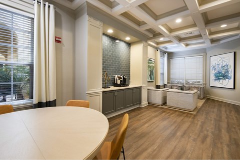 A dining room with a white table and chairs.
