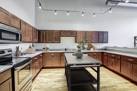 A kitchen with wooden cabinets and a black stove top oven.