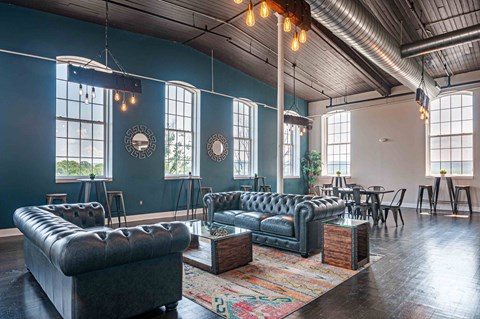A living room with a black leather sofa and a wooden coffee table.