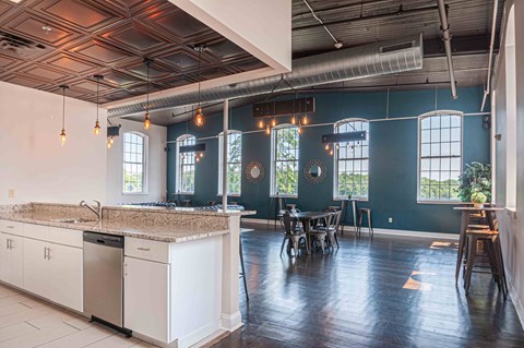 A kitchen with white cabinets and a marble countertop.