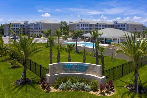 A resort with a pool and palm trees.