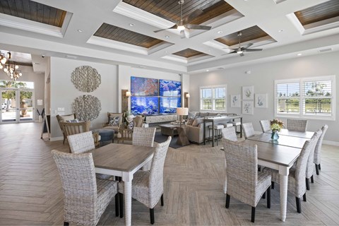 A large dining room with a long table and chairs.