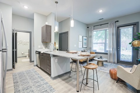A modern kitchen with a dining table and chairs.