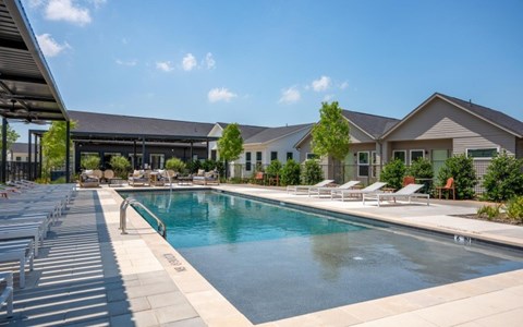a swimming pool with a building in the background