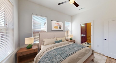 a bedroom with a bed and a ceiling fan