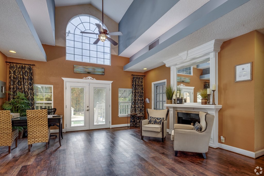 A living room with a fireplace and a dining table.
