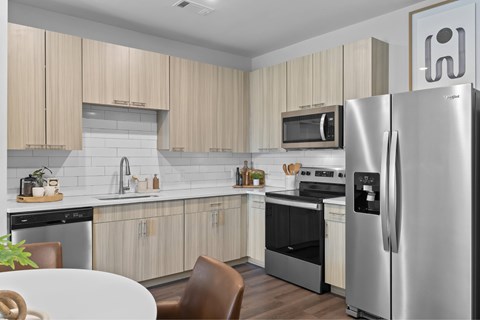 A modern kitchen with a refrigerator on the right side.