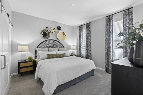 A bedroom with a large bed and a mirror on the wall.