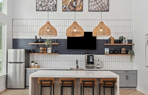 A kitchen with a white counter and a black fridge.