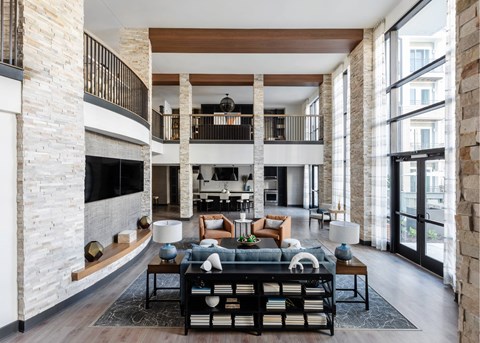 A modern living room with a black sofa and a coffee table.