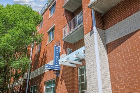 A red brick building with a blue sign that says 