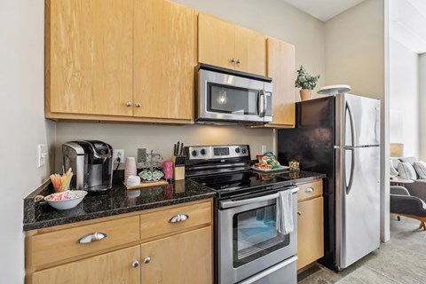 A modern kitchen with wooden cabinets and stainless steel appliances.