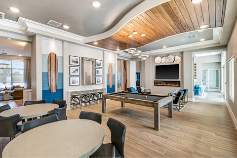 A modern dining room with a fireplace and a pool table.