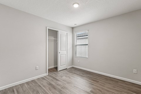 A room with a wooden floor and a white door.