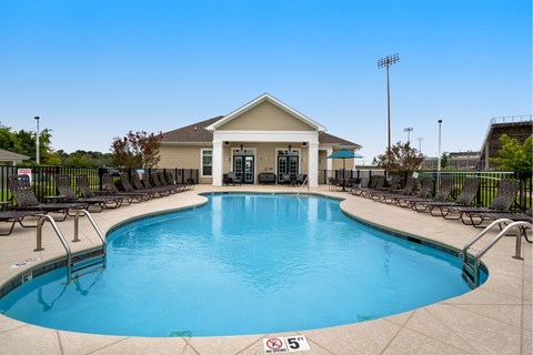 Sparkling Pool surrounded by lounge chairs