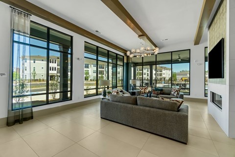 a living room with large windows and a couch