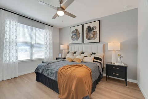 a bedroom with a bed and a ceiling fan