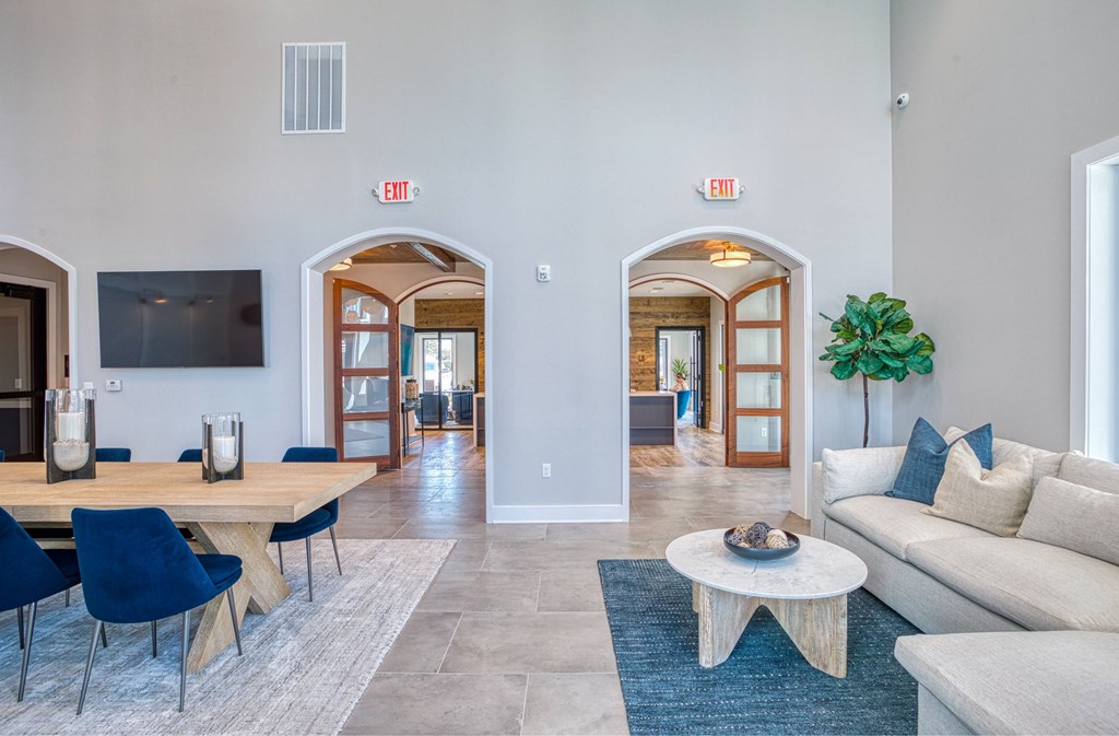 A living room with a couch, chairs, and a coffee table.