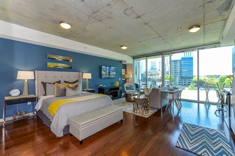 A bedroom with a large bed and a view of the city.