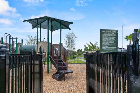 A playground with a green canopy and a sign that reads 