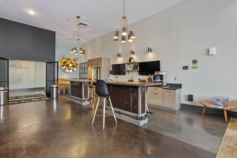 A modern kitchen with a black chair and a black table.
