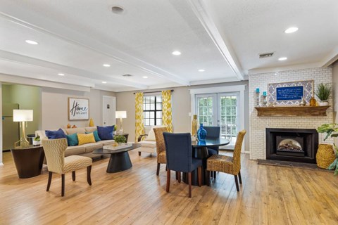 A living room with a fireplace and a dining table set up.