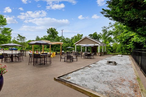 A playground with a slide and picnic tables.