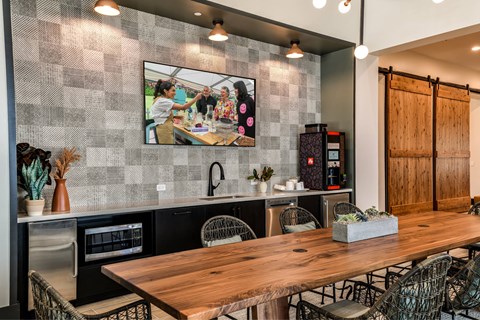 A modern kitchen with a wooden table and chairs.