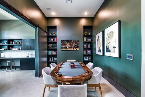 A modern dining room with a wooden table surrounded by white chairs.