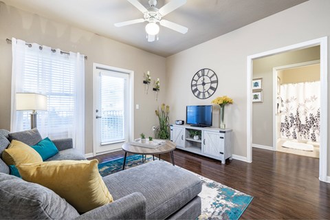A living room with a grey couch and a white entertainment center.